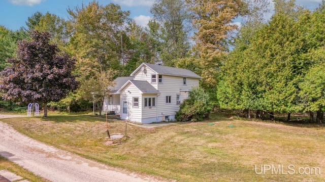 view of property exterior with a lawn