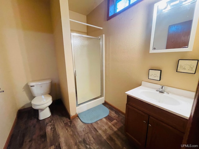 bathroom featuring vanity, toilet, an enclosed shower, and hardwood / wood-style flooring