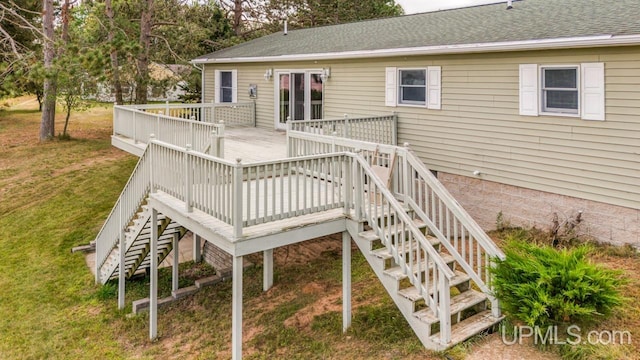 wooden deck featuring a yard