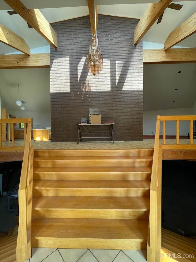 staircase featuring vaulted ceiling with beams