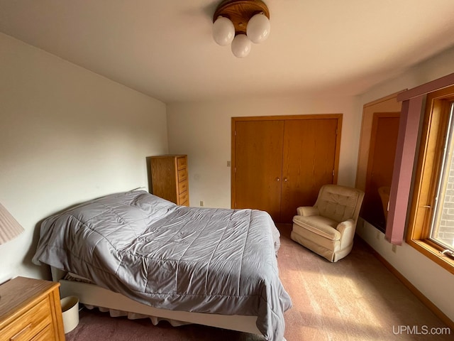 carpeted bedroom featuring a closet