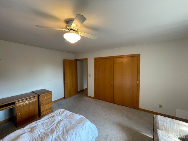 carpeted bedroom with ceiling fan and a closet