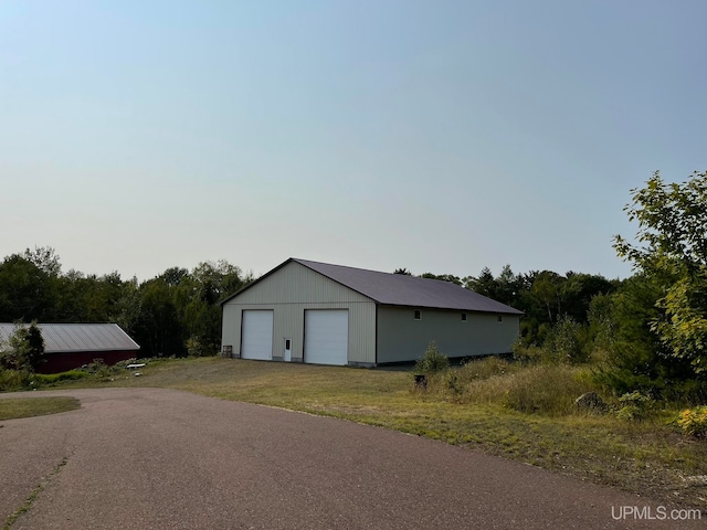 view of property exterior with an outbuilding and a garage