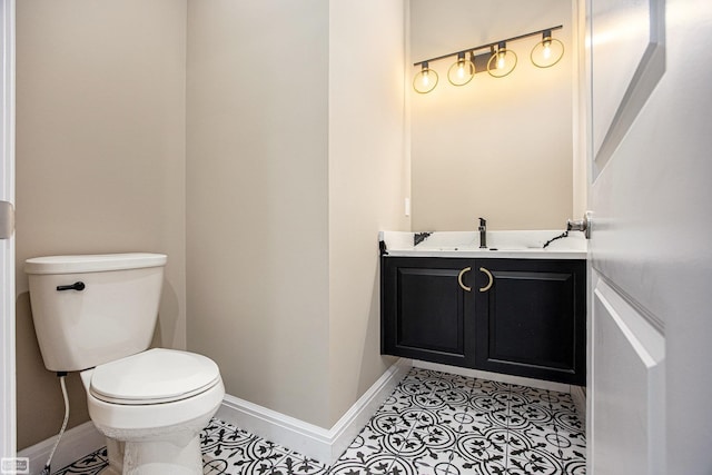 bathroom with tile patterned flooring, vanity, and toilet