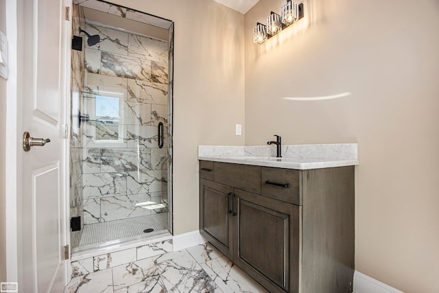 bathroom featuring a shower with door and vanity