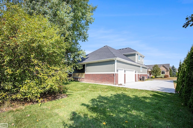 view of side of property with a yard and a garage