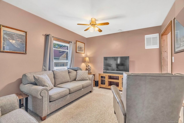 carpeted living room with ceiling fan