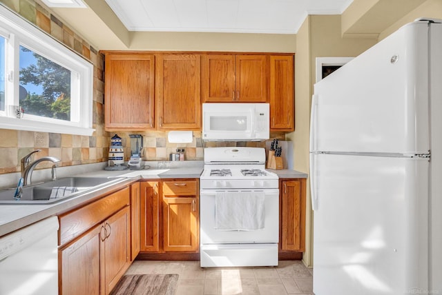 kitchen featuring light tile patterned floors, sink, white appliances, crown molding, and decorative backsplash