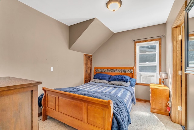 bedroom with light colored carpet and vaulted ceiling