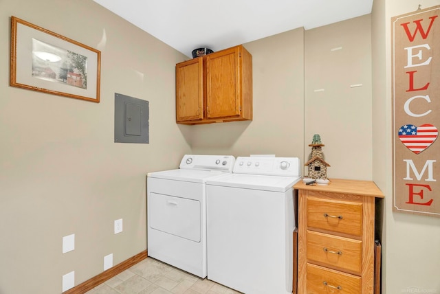 washroom featuring cabinets, washer and dryer, and electric panel