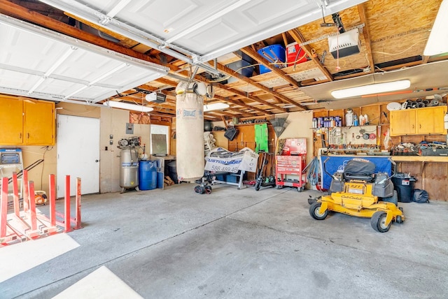 garage with a garage door opener and a workshop area