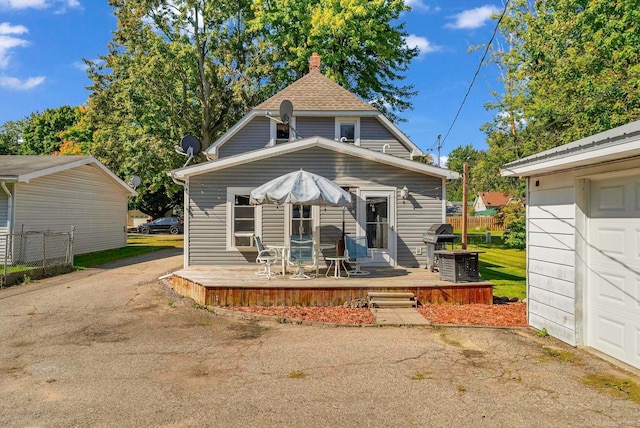 rear view of house with a wooden deck