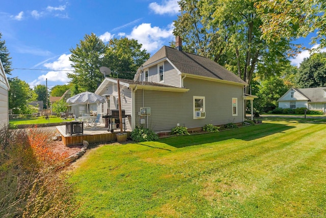 view of side of property with cooling unit, a deck, and a yard