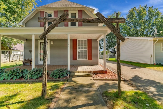 view of front of house featuring a front lawn and covered porch