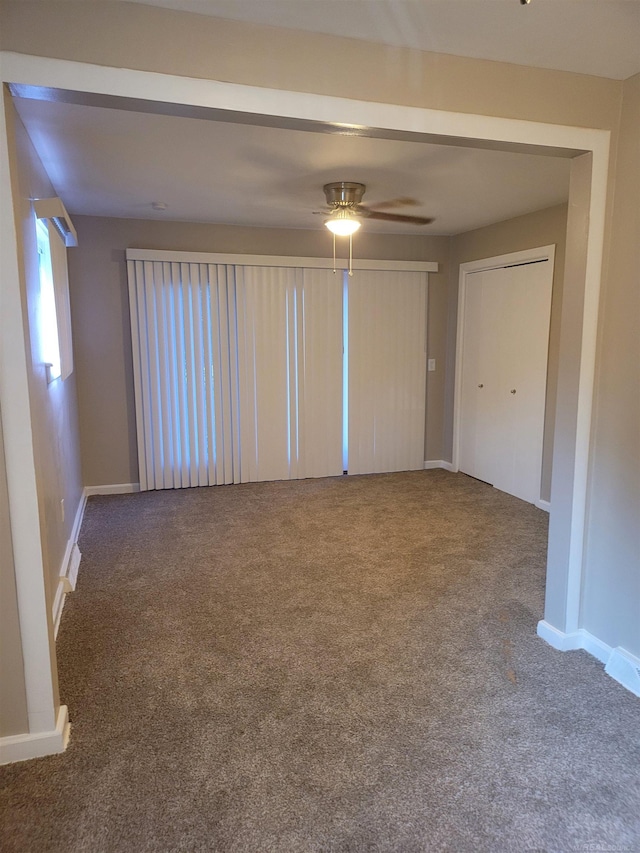 empty room featuring carpet flooring and ceiling fan