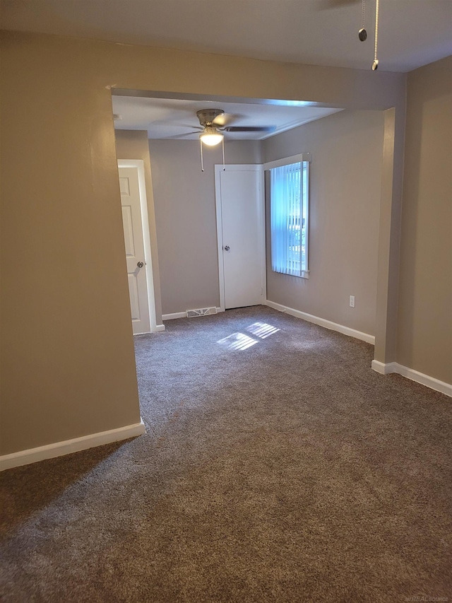 carpeted spare room with ceiling fan