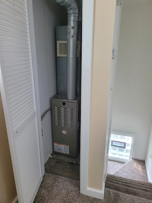 utility room featuring heating unit