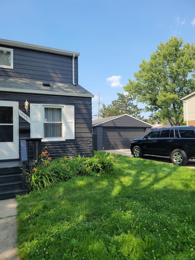 view of side of home with a garage, an outdoor structure, and a yard