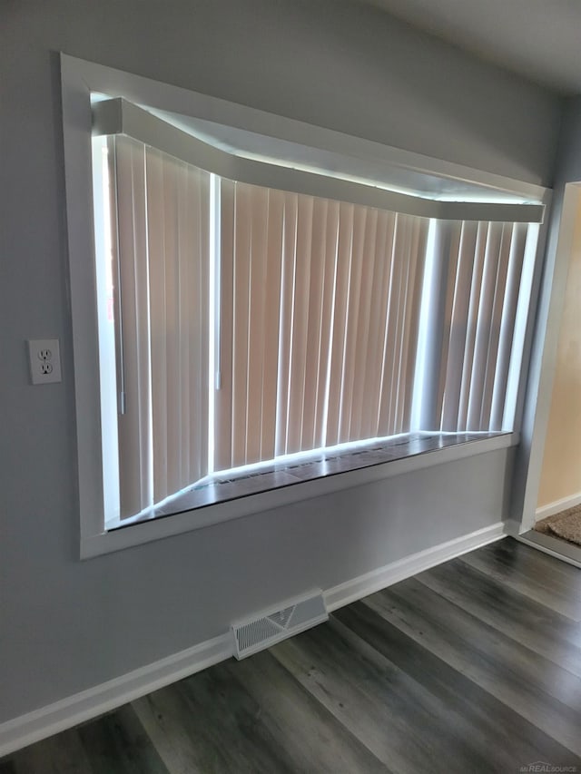 spare room featuring dark hardwood / wood-style floors and a wealth of natural light