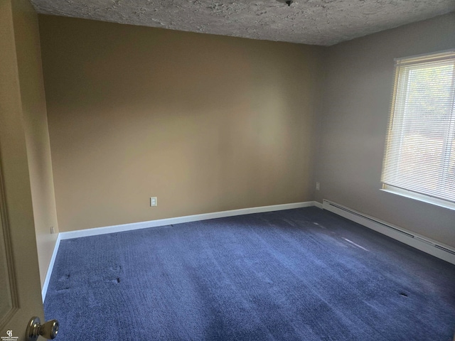 carpeted spare room with a textured ceiling