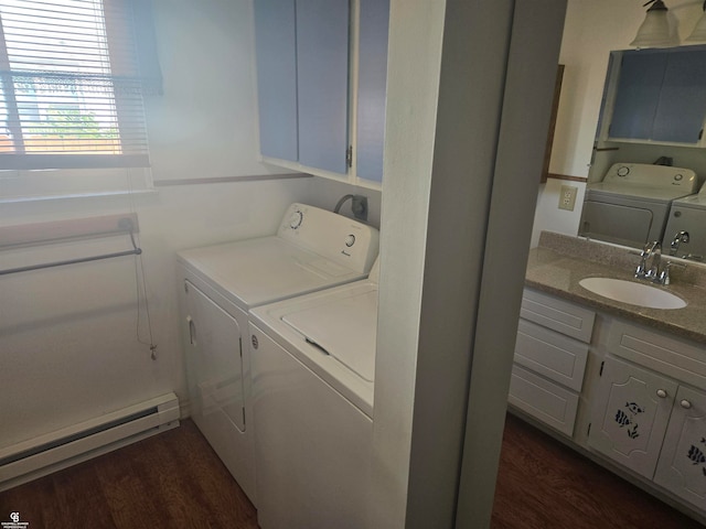 laundry area featuring dark hardwood / wood-style flooring, a baseboard heating unit, separate washer and dryer, and sink