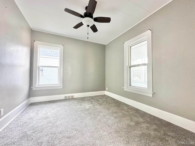 unfurnished room featuring ceiling fan and carpet flooring