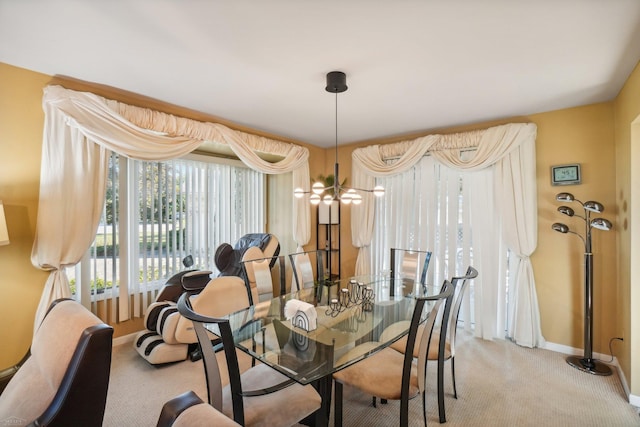 dining room featuring a notable chandelier and light colored carpet