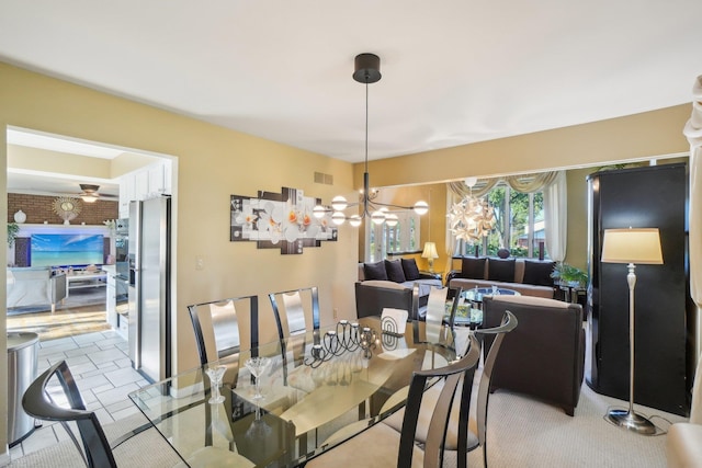 dining room with ceiling fan with notable chandelier