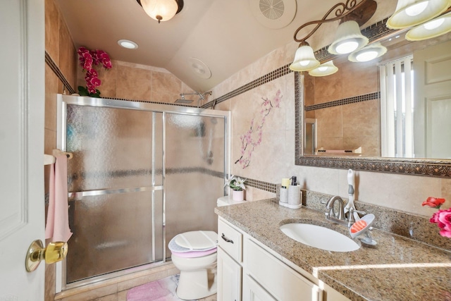 bathroom featuring vaulted ceiling, vanity, an enclosed shower, toilet, and tile patterned floors