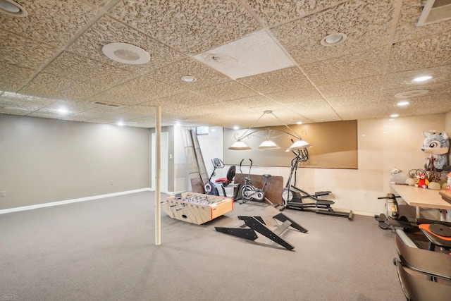 workout area with carpet and a paneled ceiling