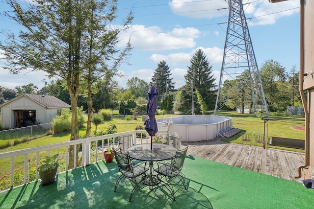 view of patio with a pool side deck and a storage shed