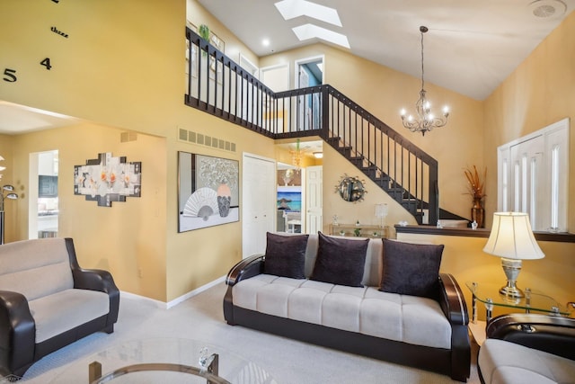 carpeted living room featuring a high ceiling, a chandelier, and a skylight