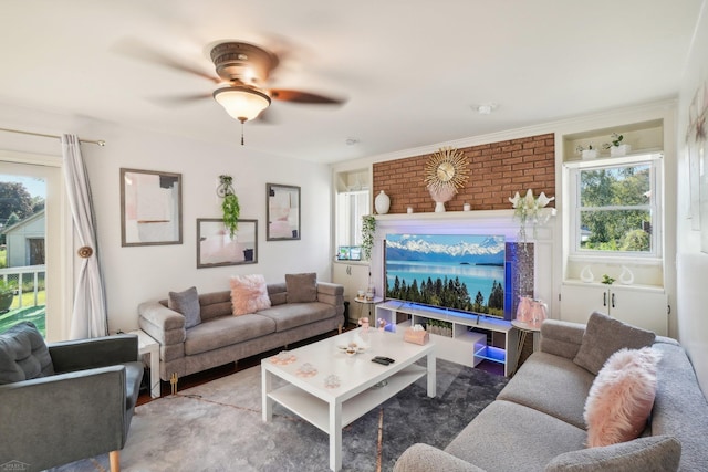 living room with ornamental molding, ceiling fan, and carpet flooring