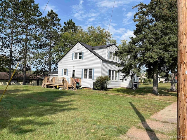 view of home's exterior with a wooden deck and a lawn