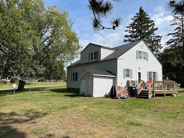 back of house featuring a lawn, a storage shed, and a deck