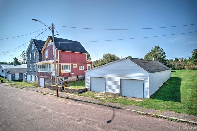 exterior space with a garage and a lawn