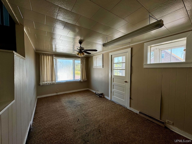 interior space featuring wood walls and ceiling fan