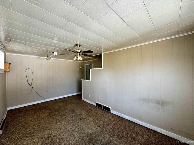 52 Senter St, Ahmeek, MI 49901 - empty room featuring carpet, ceiling fan, and wooden walls