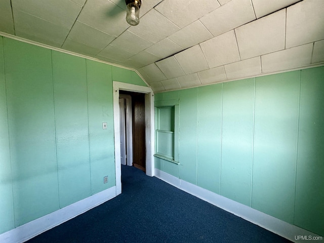 52 Senter St, Ahmeek, MI 49901 - unfurnished room with dark carpet, lofted ceiling, and a decorative wall