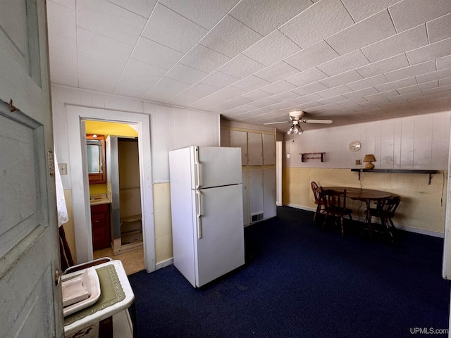 52 Senter St, Ahmeek, MI 49901 - kitchen featuring freestanding refrigerator, ceiling fan, and dark colored carpet