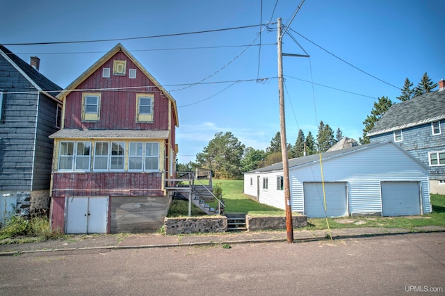 view of front of home with an outbuilding and a garage