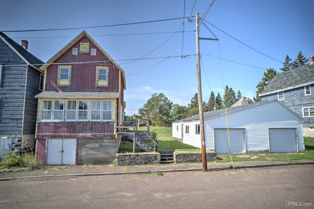 52 Senter St, Ahmeek, MI 49901 - traditional home featuring stairway, a garage, and an outdoor structure
