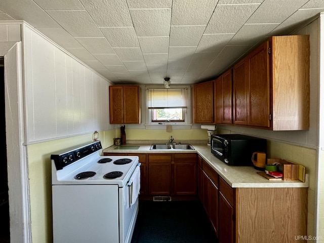 52 Senter St, Ahmeek, MI 49901 - kitchen with electric range, black microwave, light countertops, and brown cabinetry