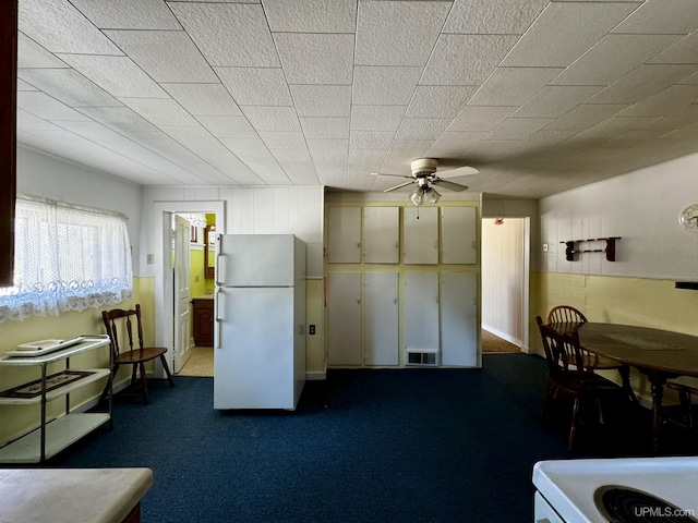 52 Senter St, Ahmeek, MI 49901 - kitchen featuring freestanding refrigerator, a ceiling fan, and dark colored carpet