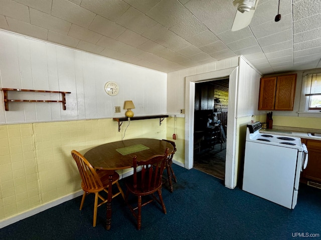 dining room with dark carpet and ceiling fan