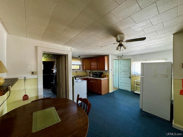 kitchen featuring ceiling fan and white refrigerator