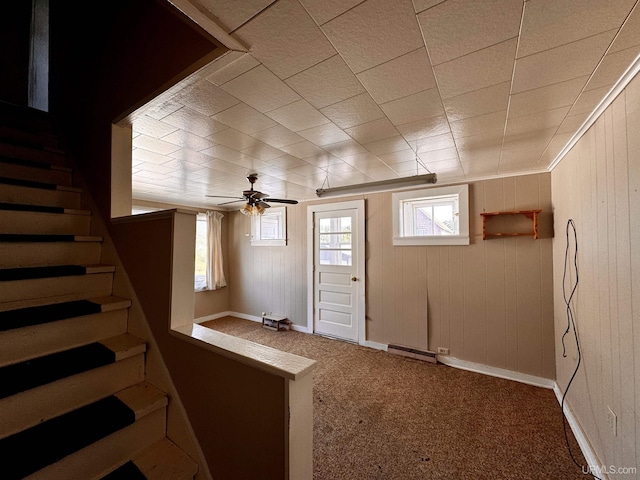 52 Senter St, Ahmeek, MI 49901 - basement featuring carpet floors, ceiling fan, stairway, and wood walls