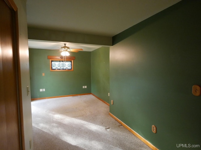 carpeted spare room with ceiling fan