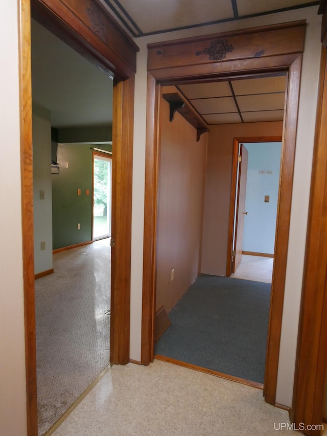 hall featuring a paneled ceiling