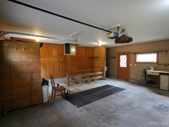 garage with wooden walls and a garage door opener